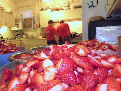 a big bowl of strawberries in the kitchen