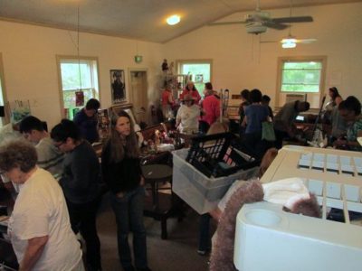 a room full of people looking at objects to buy